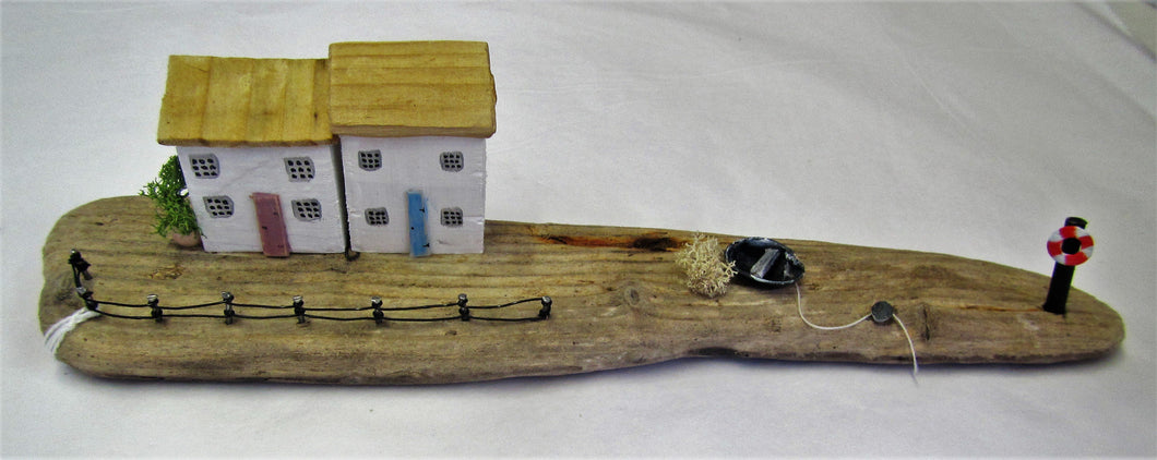 Beautiful handcrafted driftwood two cottage with  boat