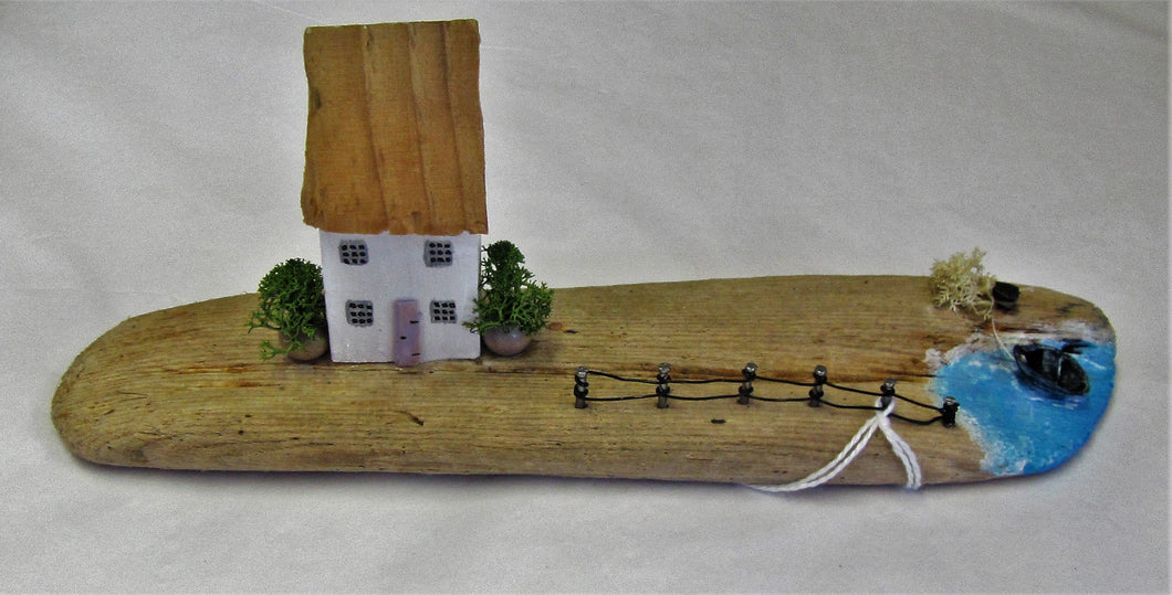 Beautiful handcrafted driftwood cottage with sea and boat