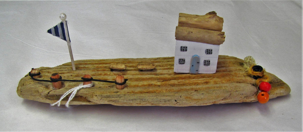 Beautiful handcrafted driftwood harbour side cottage with flag