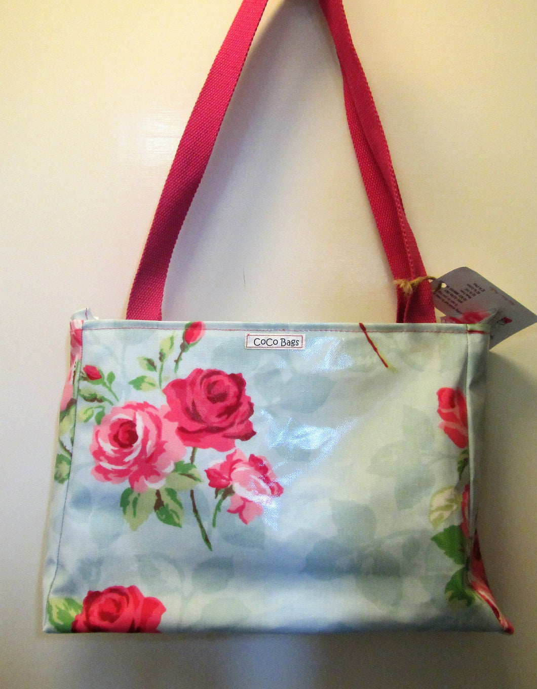 Beautiful handcrafted blue with pink roses wax fabric handbag with two pink handles