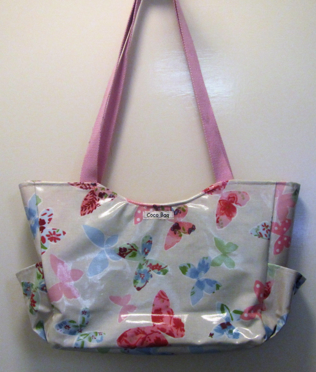 Beautiful handcrafted butterflies wax fabric handbag with two pink handles