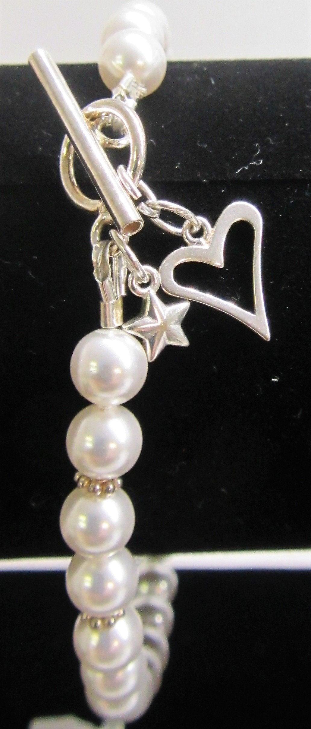 Beautiful handcrafted bracelet with swarovski pearls and silver heart and star